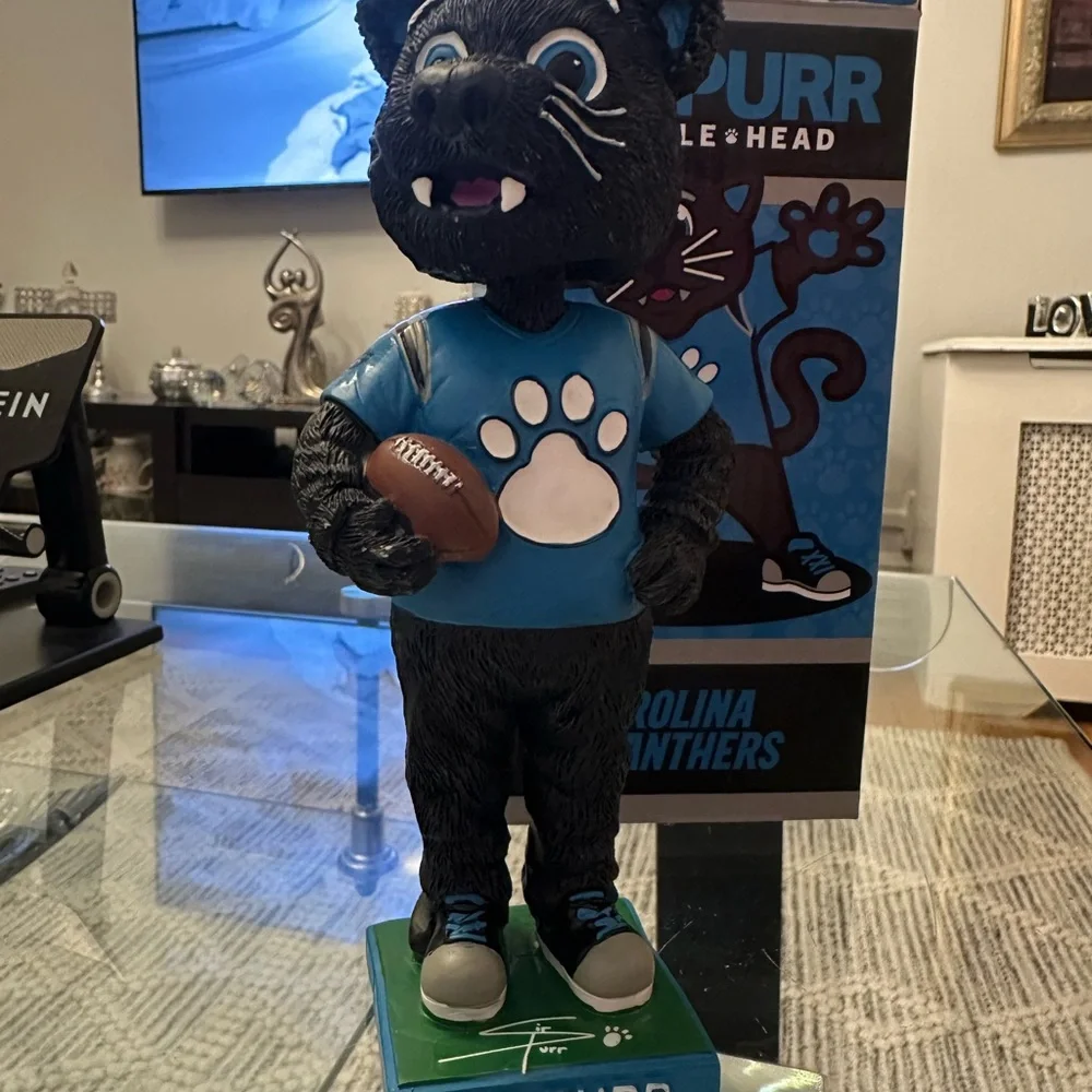 The item in the image is a Sir Purr Carolina Panthers mascot figurine/statue.